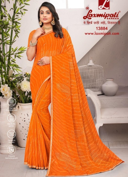 Buy Now Add a pop of color to your daily attire with our Gajari Chiffon  Saree. This saree exudes elegance with its rich Gajari shade and delicate  Jari work with stone embellishments.